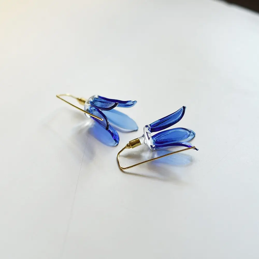 handcrafted cobalt blue lampwork glass floral bell drop earrings with brass hook wire in vibrant translucent finish