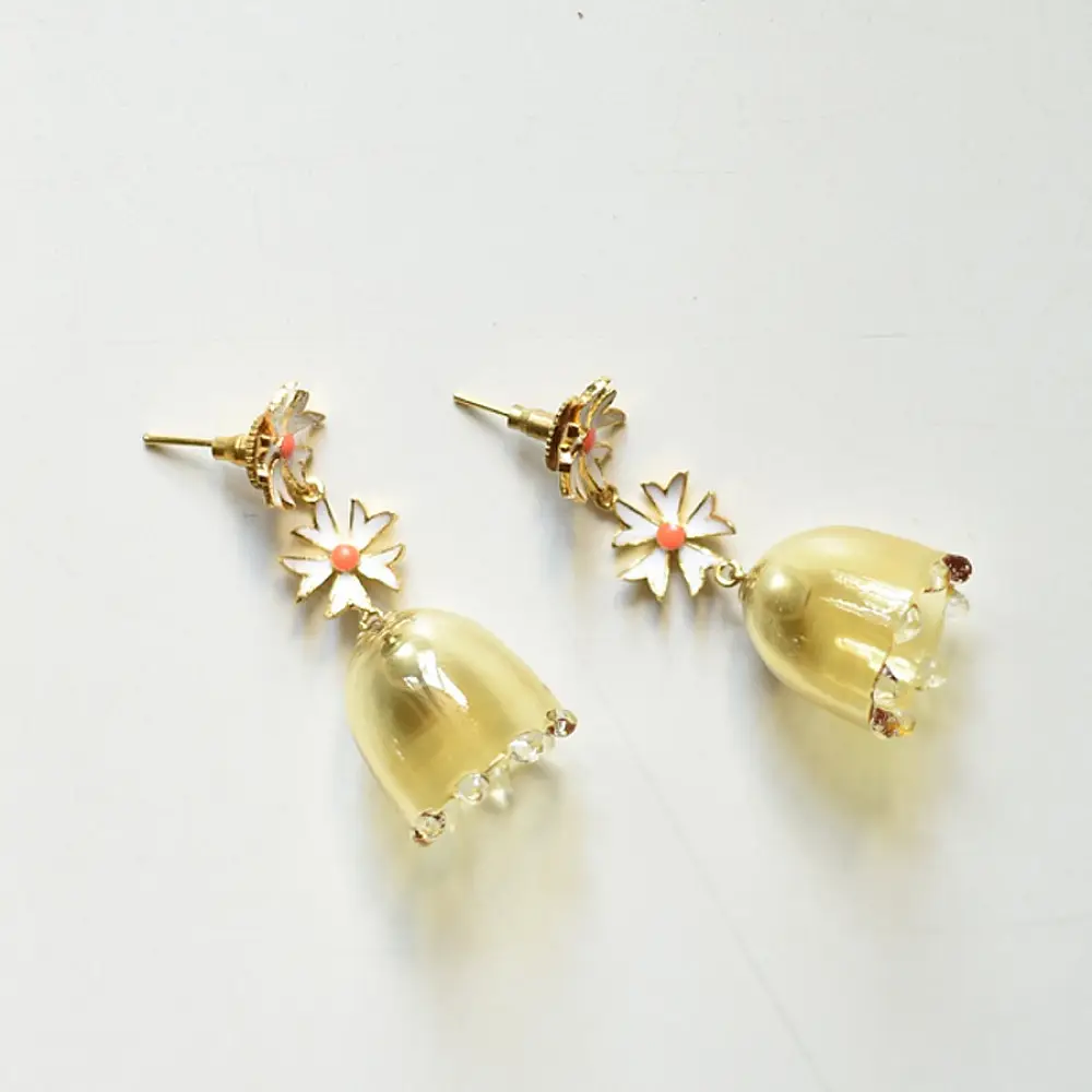 handcrafted pushpa bell jhumka drop earrings featuring a translucent yellow glass bell and white daisy floral stud top   