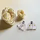 handcrafted translucent pale pink glass moth stud earrings featuring textured grooved wings and yellow spot accents