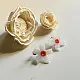 handcrafted shiuli flower glass stud earrings featuring white petaled blooms with vibrant orange center cores   