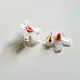 handcrafted shiuli flower glass stud earrings featuring white petaled blooms with vibrant orange center cores   