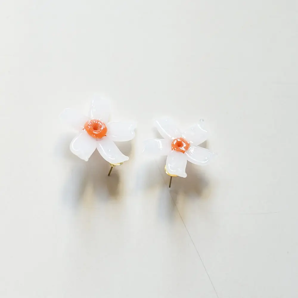 handcrafted shiuli flower glass stud earrings featuring white petaled blooms with vibrant orange center cores   