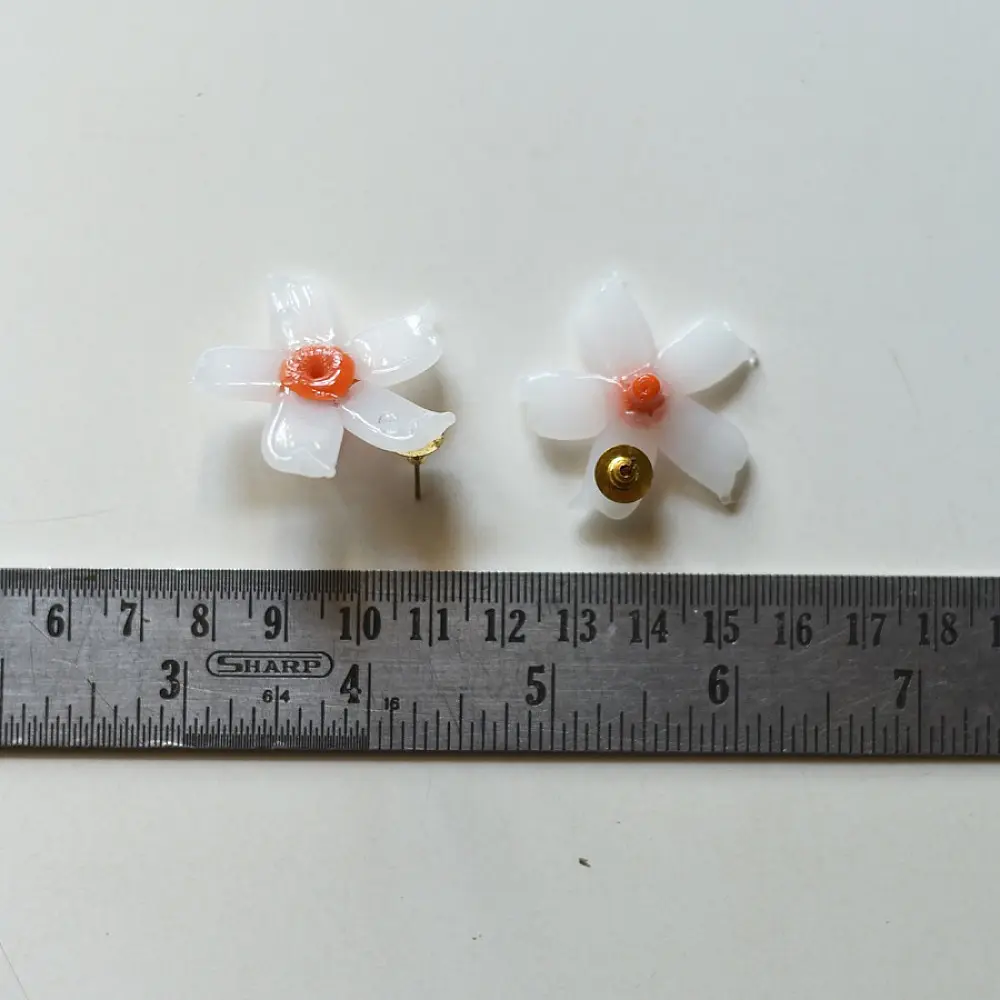 handcrafted shiuli flower glass stud earrings featuring white petaled blooms with vibrant orange center cores   