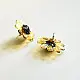 handcrafted translucent amber yellow glass bloom stud earrings with a dark textured center cap on brass post backs