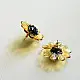 handcrafted translucent amber yellow glass bloom stud earrings with a dark textured center cap on brass post backs