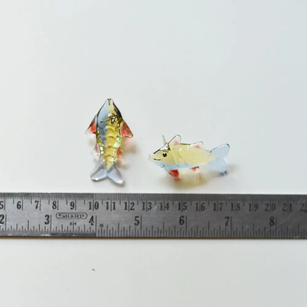 handcrafted glass fish drop earrings featuring yellow and red translucent bodies with delicate light blue fins on hook wires