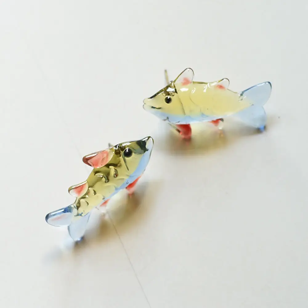 handcrafted glass fish drop earrings featuring yellow and red translucent bodies with delicate light blue fins on hook wires