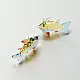 handcrafted glass fish drop earrings featuring yellow and red translucent bodies with delicate light blue fins on hook wires