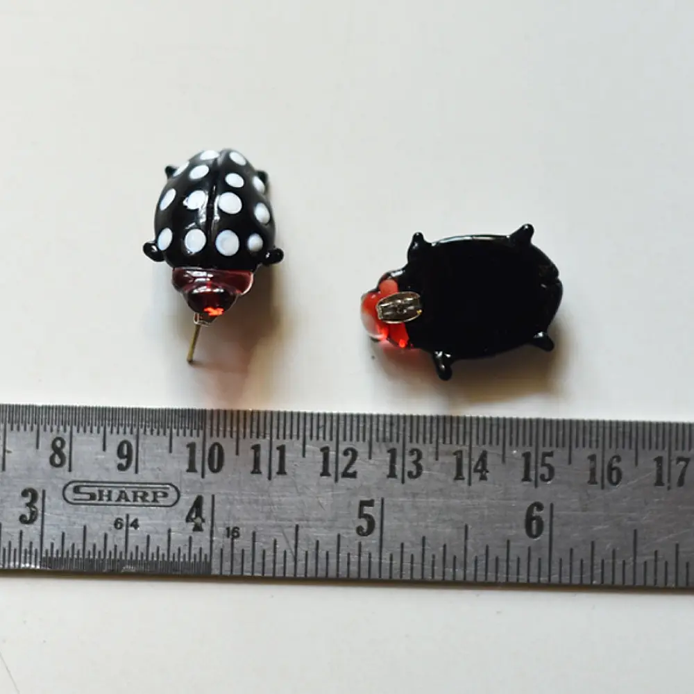 handcrafted black and white polka dot ladybug lampwork glass stud earrings named polka bug with red head accents   