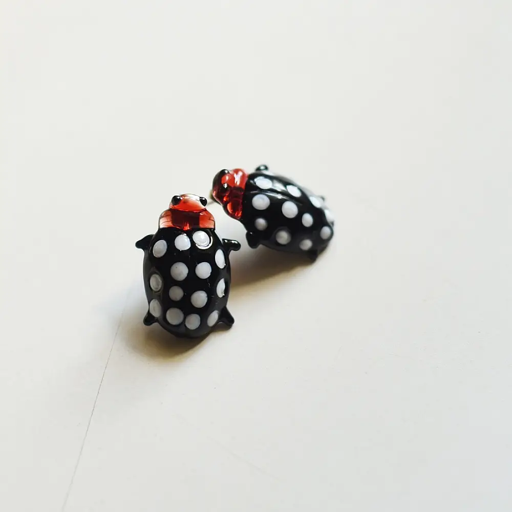 handcrafted black and white polka dot ladybug lampwork glass stud earrings named polka bug with red head accents   