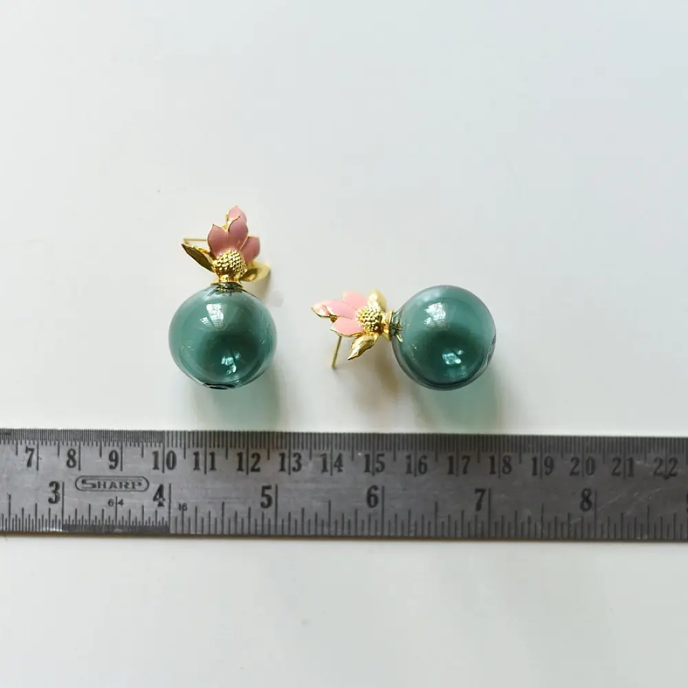 handcrafted deep emerald green glass orb stud earrings crowned with a lotus bud top on brass posts