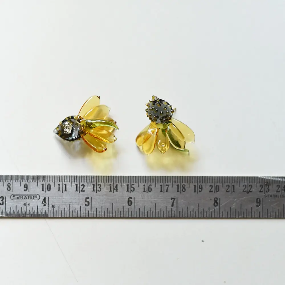 handcrafted translucent amber yellow glass sunflower stud earrings featuring a textured dark beaded center cap