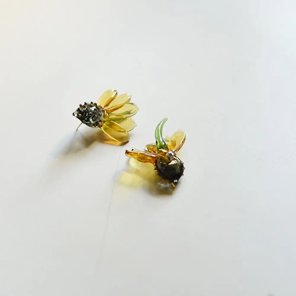 handcrafted translucent amber yellow glass sunflower stud earrings featuring a textured dark beaded center cap