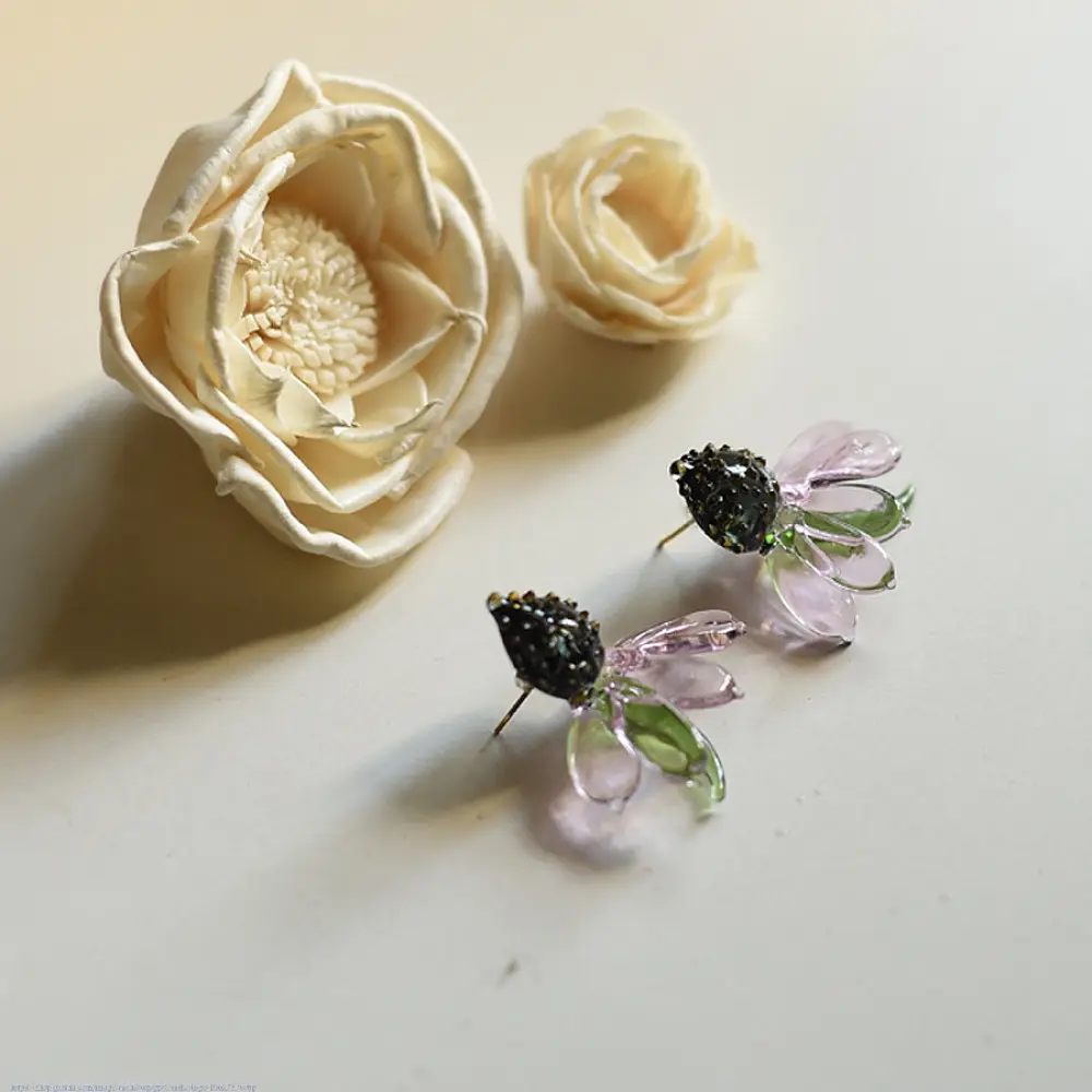 handcrafted translucent amber yellow glass sunflower stud earrings featuring a textured dark beaded center cap