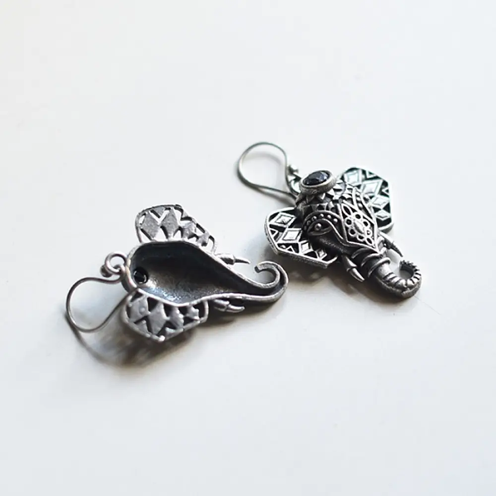 handcrafted german silver ganesha drop earrings featuring a sculpted elephant head motif, intricate ear filigree, trunk detail, and oxidised antique finish