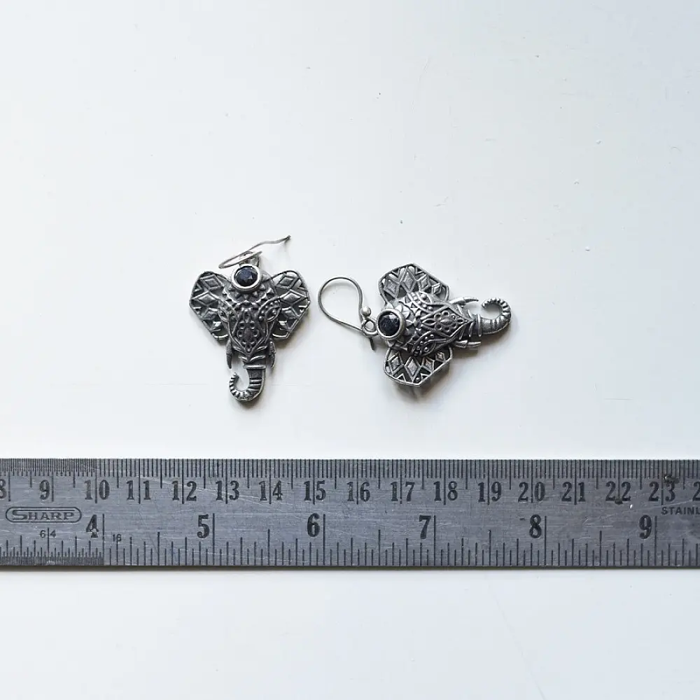 handcrafted german silver ganesha drop earrings featuring a sculpted elephant head motif, intricate ear filigree, trunk detail, and oxidised antique finish