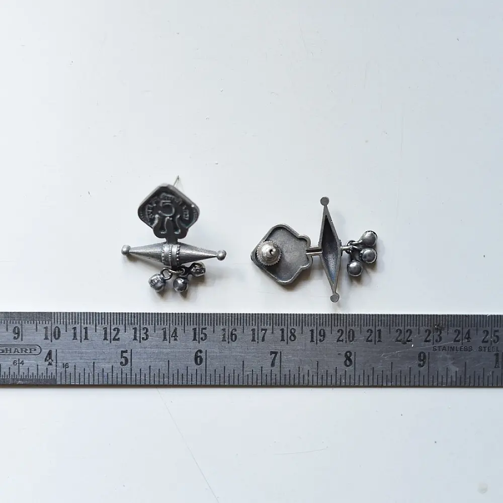 handcrafted german silver trishul stud earrings featuring lord shiva sacred trident motif, central damru drum detail, and oxidised antique finish