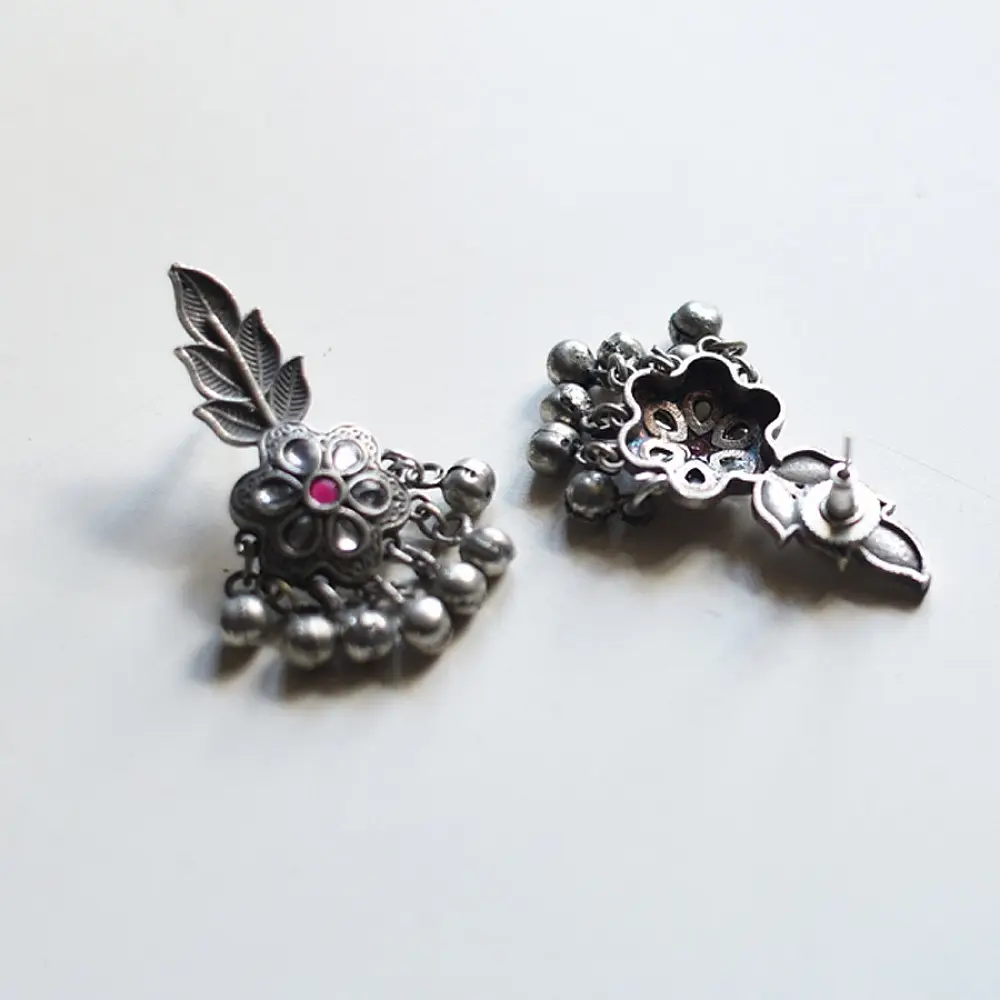 handcrafted german silver floral cluster stud earrings featuring a stone-studded blossom, textured leaf branch, and ruby red inlays