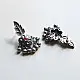 handcrafted german silver floral cluster stud earrings featuring a stone-studded blossom, textured leaf branch, and ruby red inlays