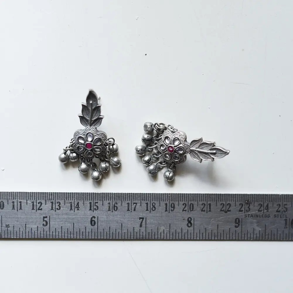 handcrafted german silver floral cluster stud earrings featuring a stone-studded blossom, textured leaf branch, and ruby red inlays