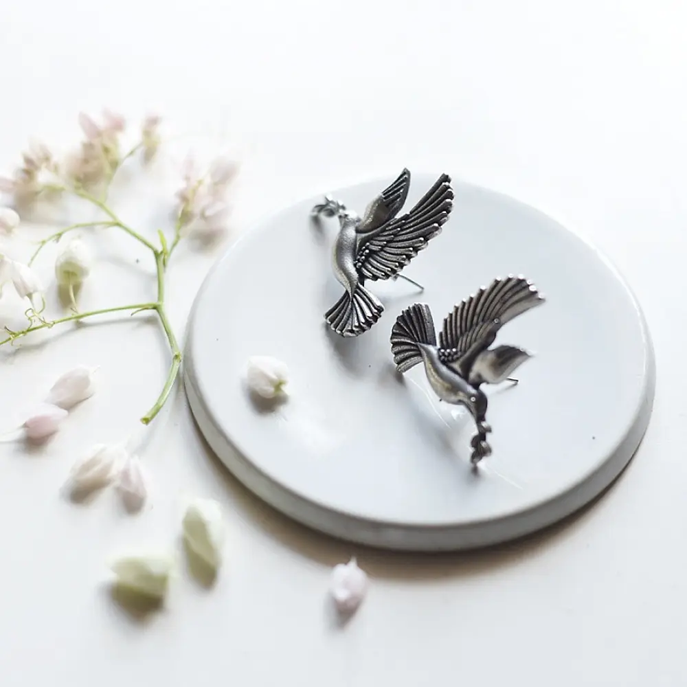 handcrafted german silver bird stud earrings featuring finely detailed spread wings, oxidised finish, and ethnic tribal jewelry design