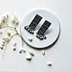 handcrafted german silver geometric rectangular drop earrings featuring woven triangular lattice cutouts, textured stud top, and dangling ghungroo bead cluster