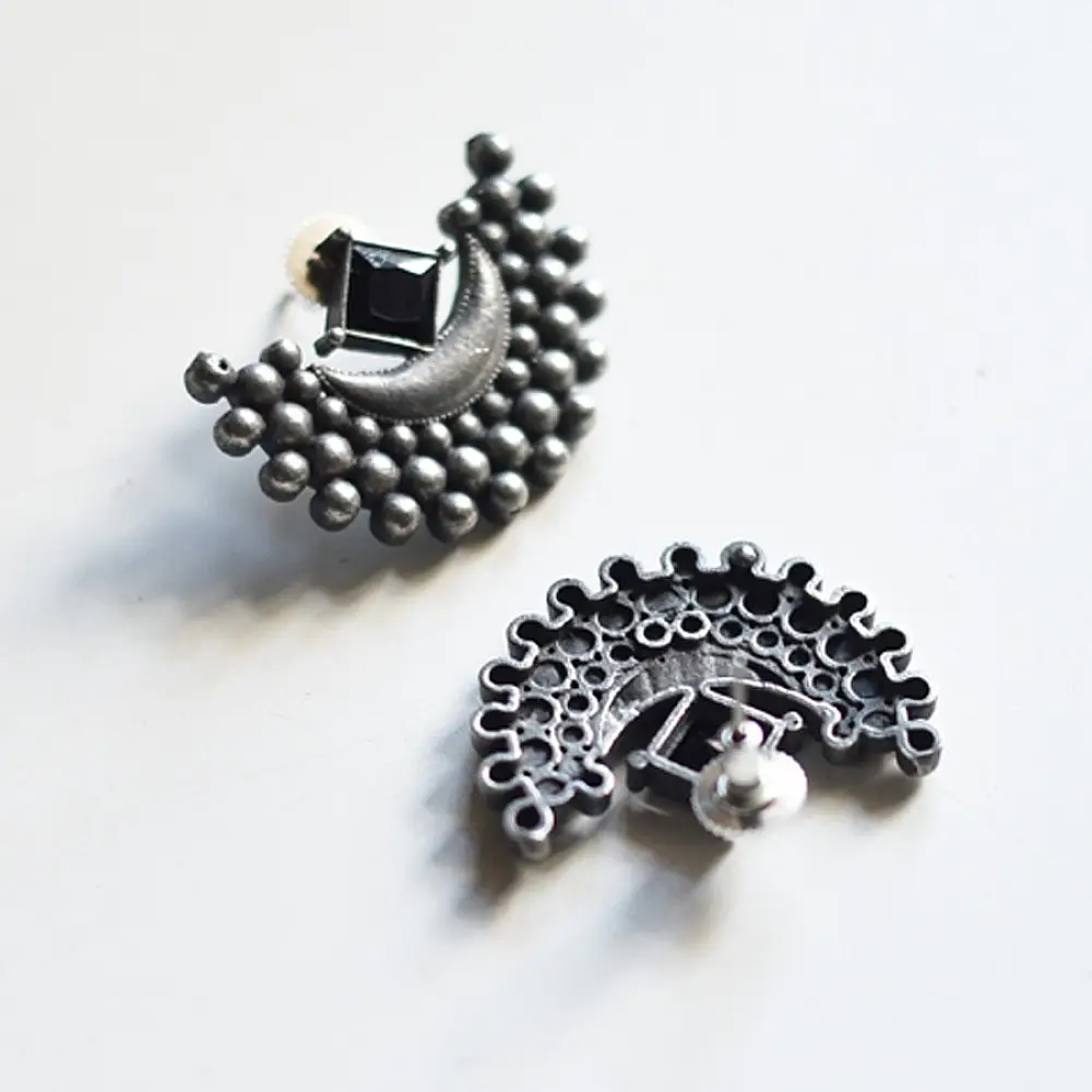 handcrafted german silver crescent stud earrings featuring a polished half-moon central frame bordered with radiating granulated beads in oxidised finish