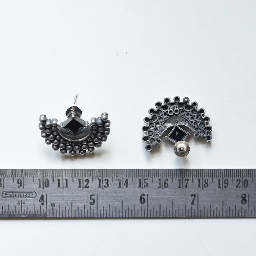handcrafted german silver crescent stud earrings featuring a polished half-moon central frame bordered with radiating granulated beads in oxidised finish