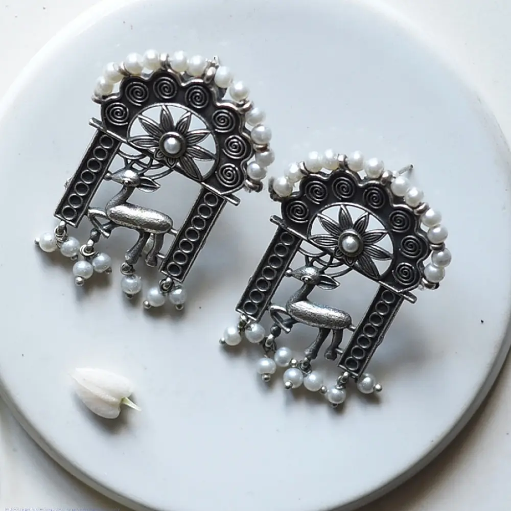 handcrafted german silver arch stud earrings featuring an ornate deer motif, beaded filigree, and dangling faux pearl clusters