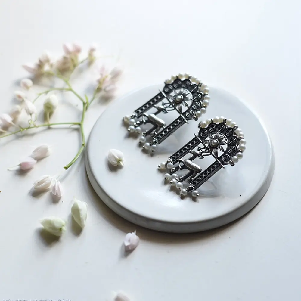 handcrafted german silver arch stud earrings featuring an ornate deer motif, beaded filigree, and dangling faux pearl clusters