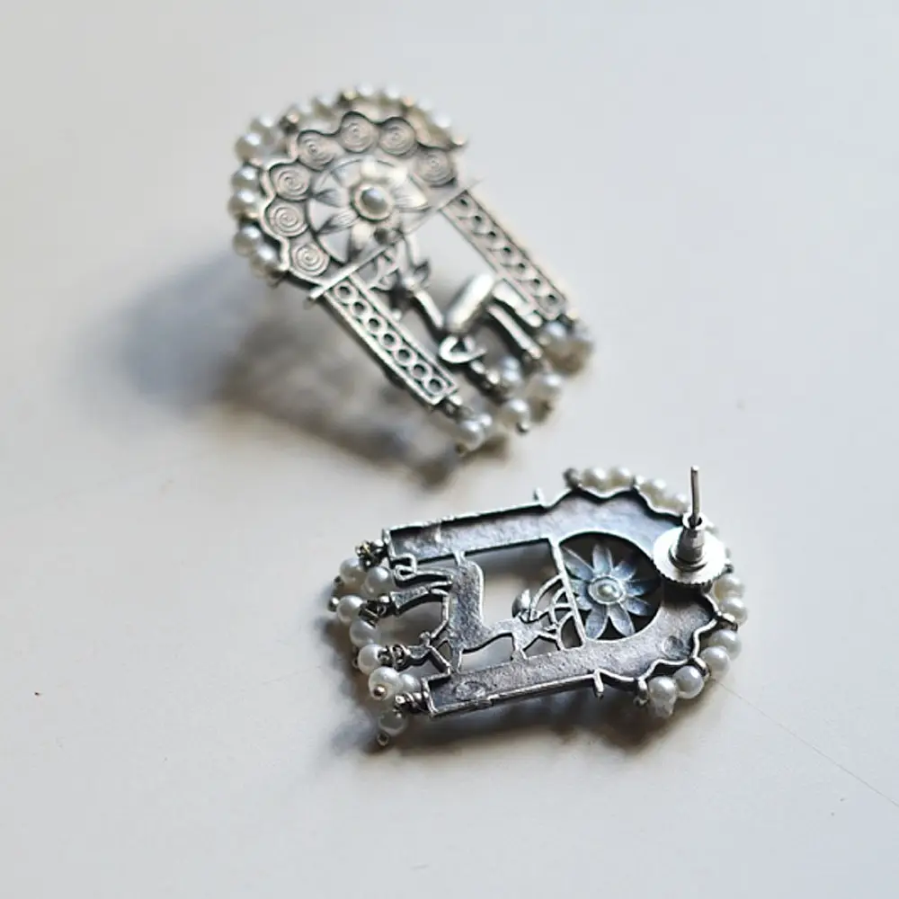 handcrafted german silver arch stud earrings featuring an ornate deer motif, beaded filigree, and dangling faux pearl clusters