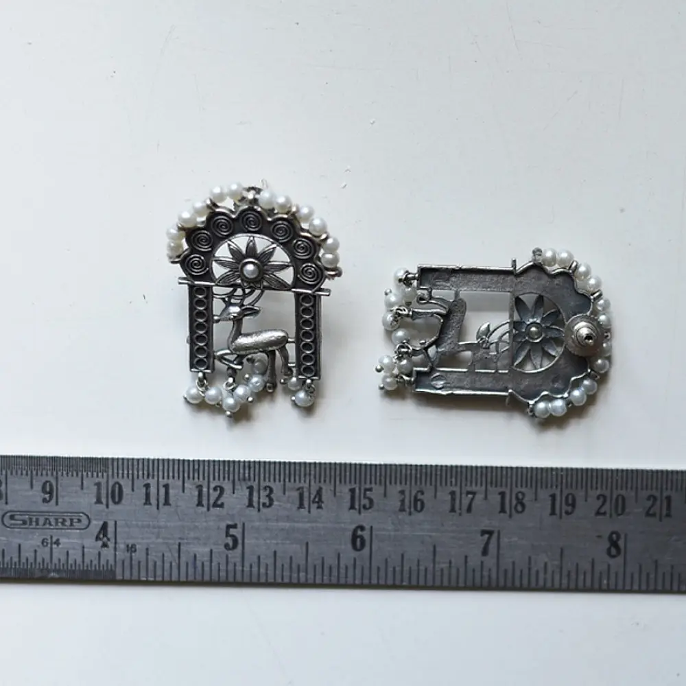 handcrafted german silver arch stud earrings featuring an ornate deer motif, beaded filigree, and dangling faux pearl clusters