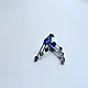 handcrafted german silver bird stud earrings featuring a cobalt blue stone body, jewel-toned glass inlays, and dangling ruby red teardrop tail accent