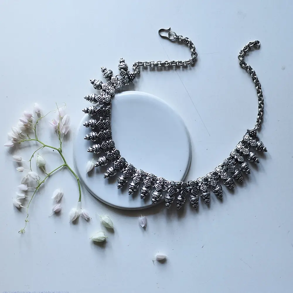 handcrafted german silver choker necklace featuring textured pinecone drop units, beaded collar band, and oxidised antique finish