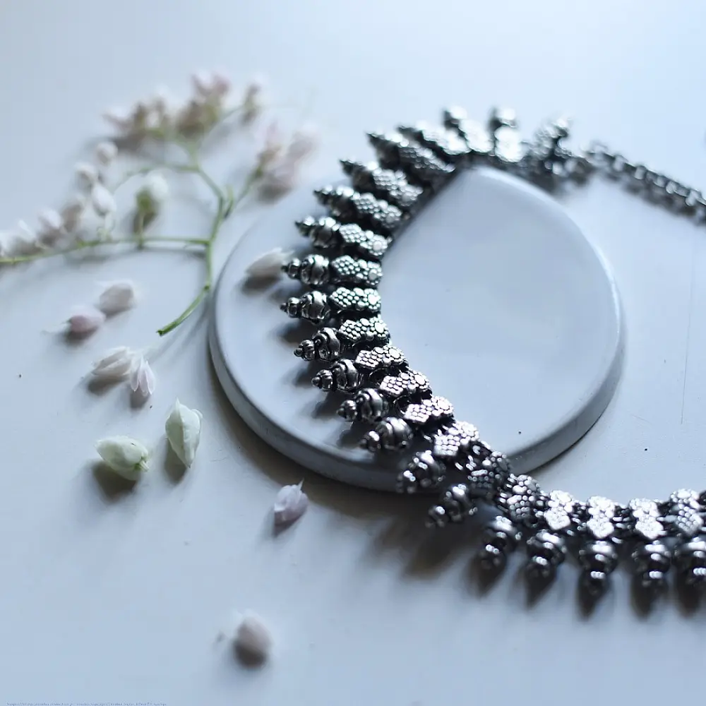 handcrafted german silver choker necklace featuring textured pinecone drop units, beaded collar band, and oxidised antique finish