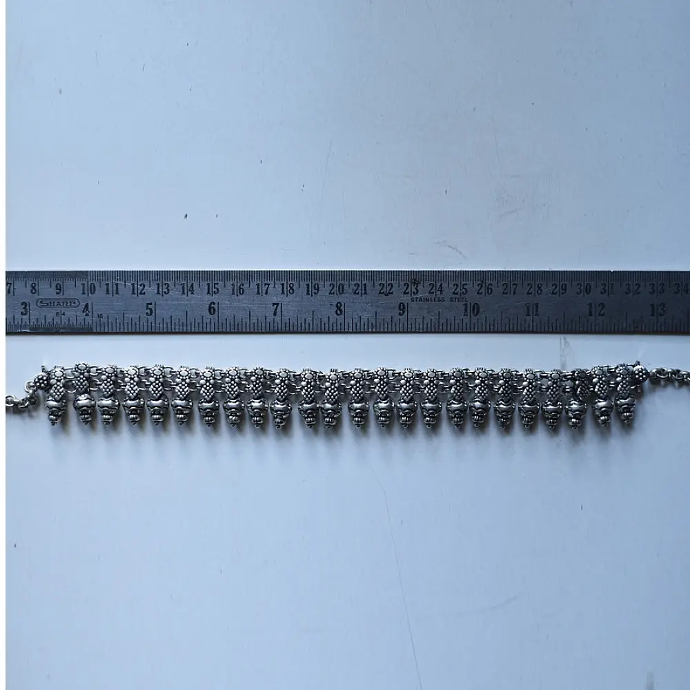 handcrafted german silver choker necklace featuring textured pinecone drop units, beaded collar band, and oxidised antique finish