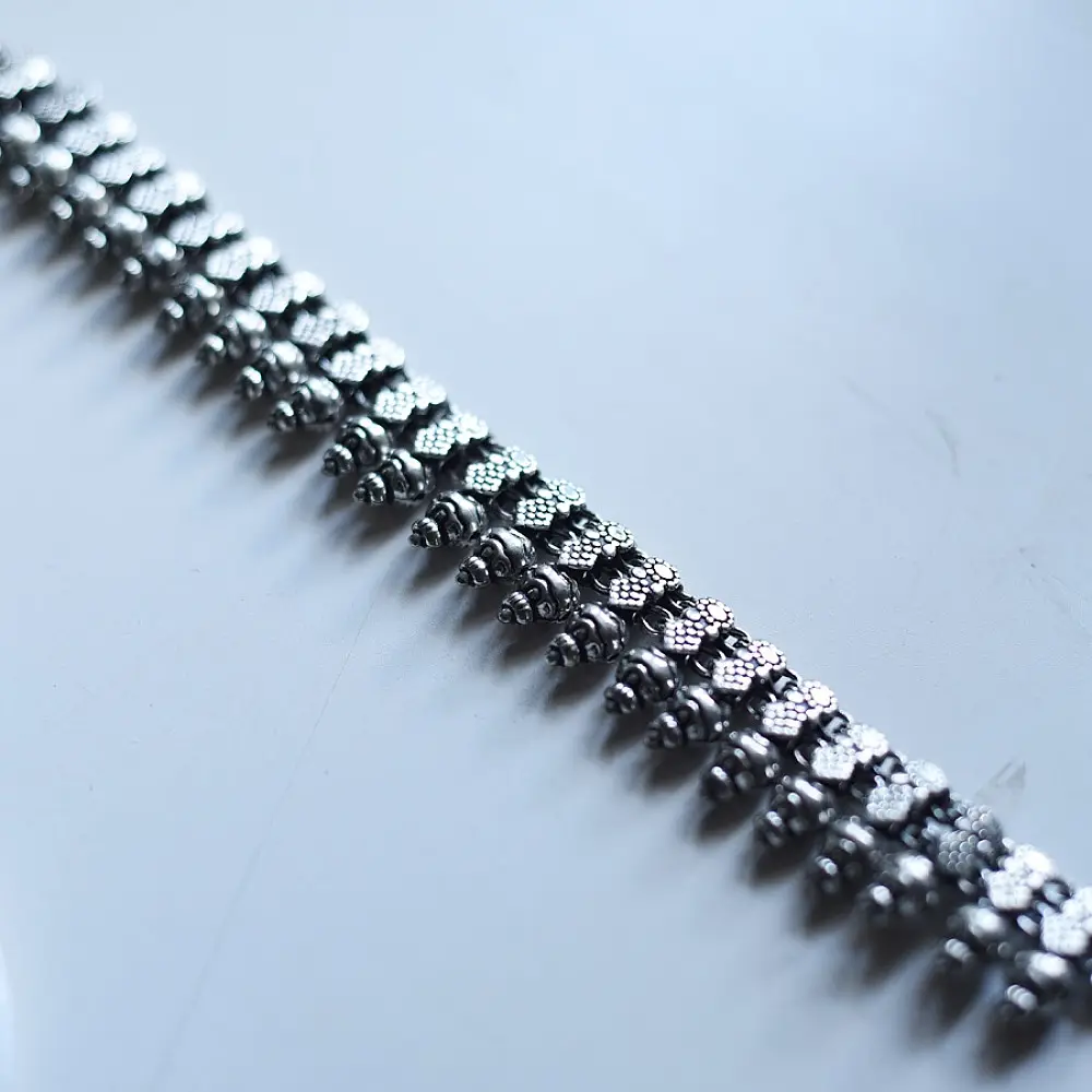 handcrafted german silver choker necklace featuring textured pinecone drop units, beaded collar band, and oxidised antique finish