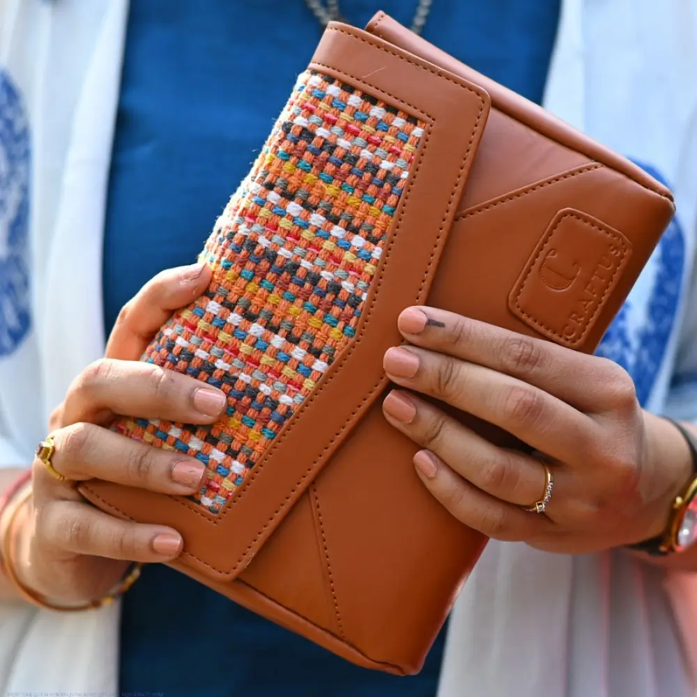 brown Panja Dhurrie purse with multicolour handwoven textile panel and envelope-style design
