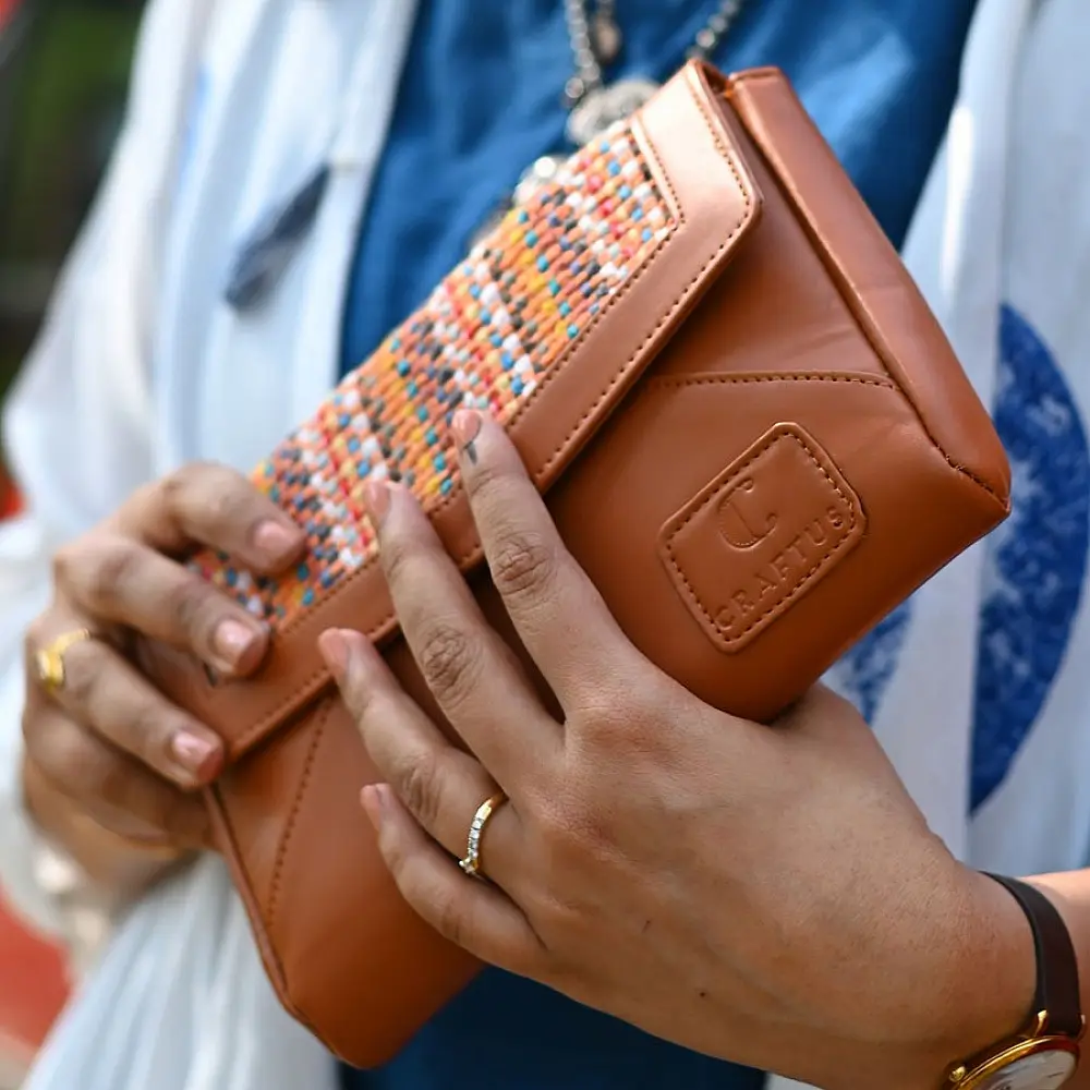 brown Panja Dhurrie purse with multicolour handwoven textile panel and envelope-style design