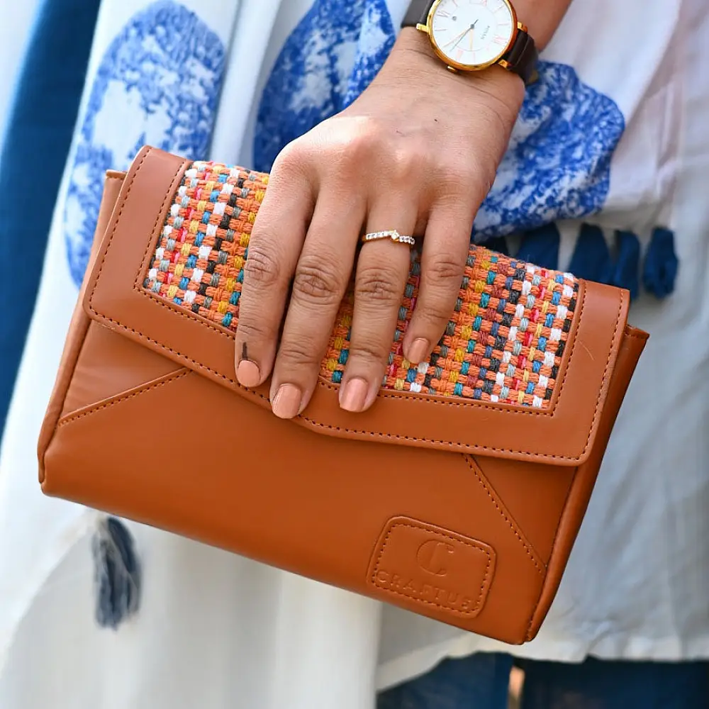 brown Panja Dhurrie purse with multicolour handwoven textile panel and envelope-style design