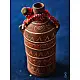 terracotta water bottle with white hand-painted geometric motifs and multicolour cord wrapped neck