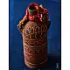 terracotta water bottle with white hand-painted geometric motifs and multicolour cord wrapped neck