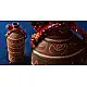 terracotta water bottle with white hand-painted geometric motifs and multicolour cord wrapped neck