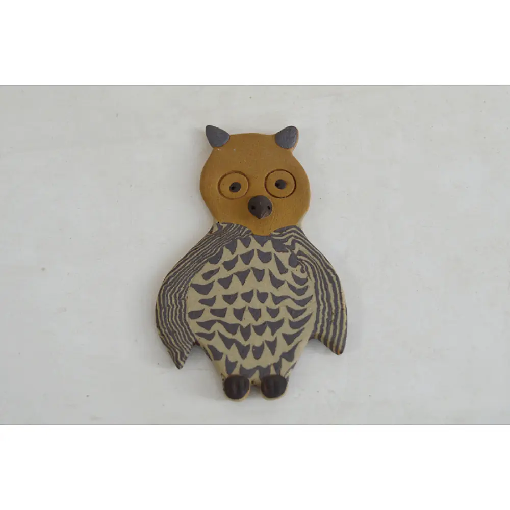handmade terracotta clay owl fridge magnet with tan head and etched feather pattern body