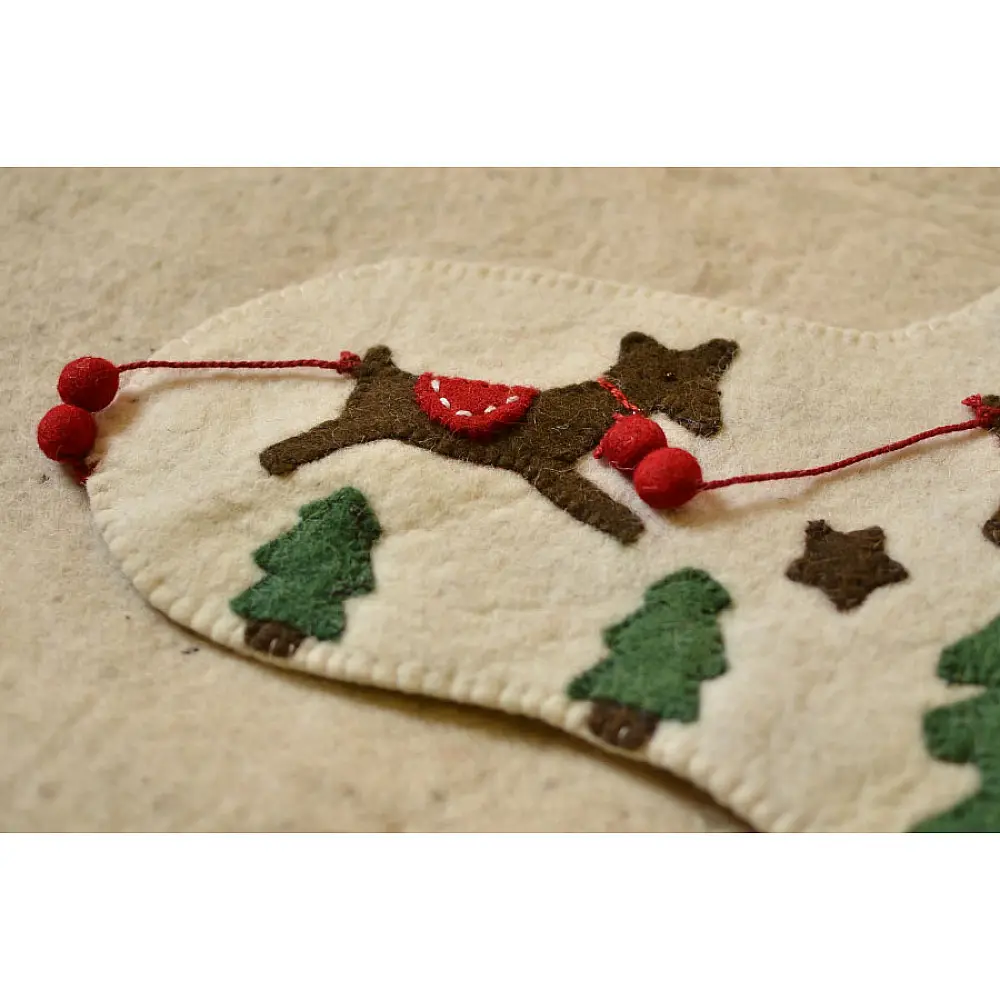 cream felt Christmas stocking candy sock featuring handcrafted green holly leaves and red berry accents