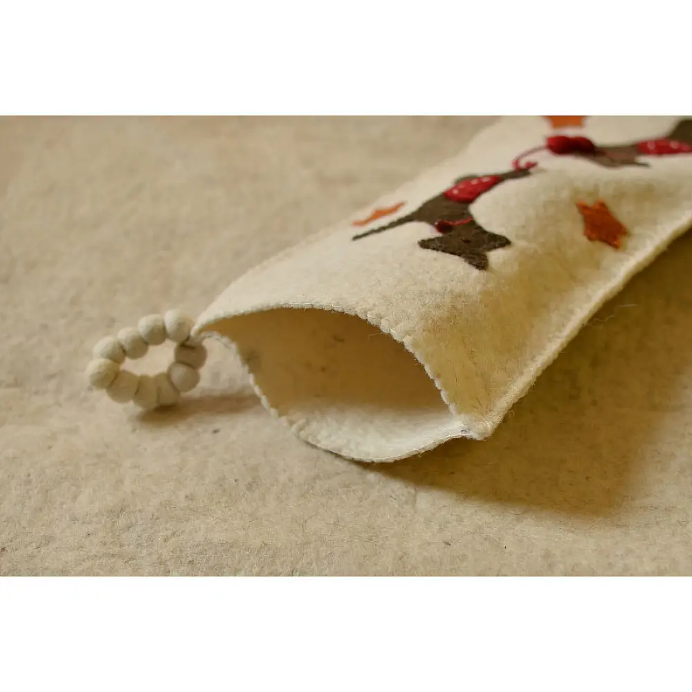 cream felt Christmas stocking candy sock featuring handcrafted green holly leaves and red berry accents