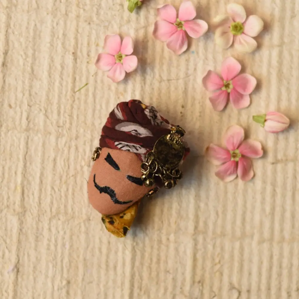 maldhari man hand embroidered fabric brooch pin with traditional patterned turban metallic ring earrings mustache details lapel badge gaatha