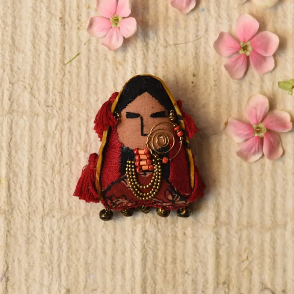 woman of kutchh hand embroidered fabric brooch pin with traditional large gold nose ring tribal jewelry thread tassels lapel badge gaatha