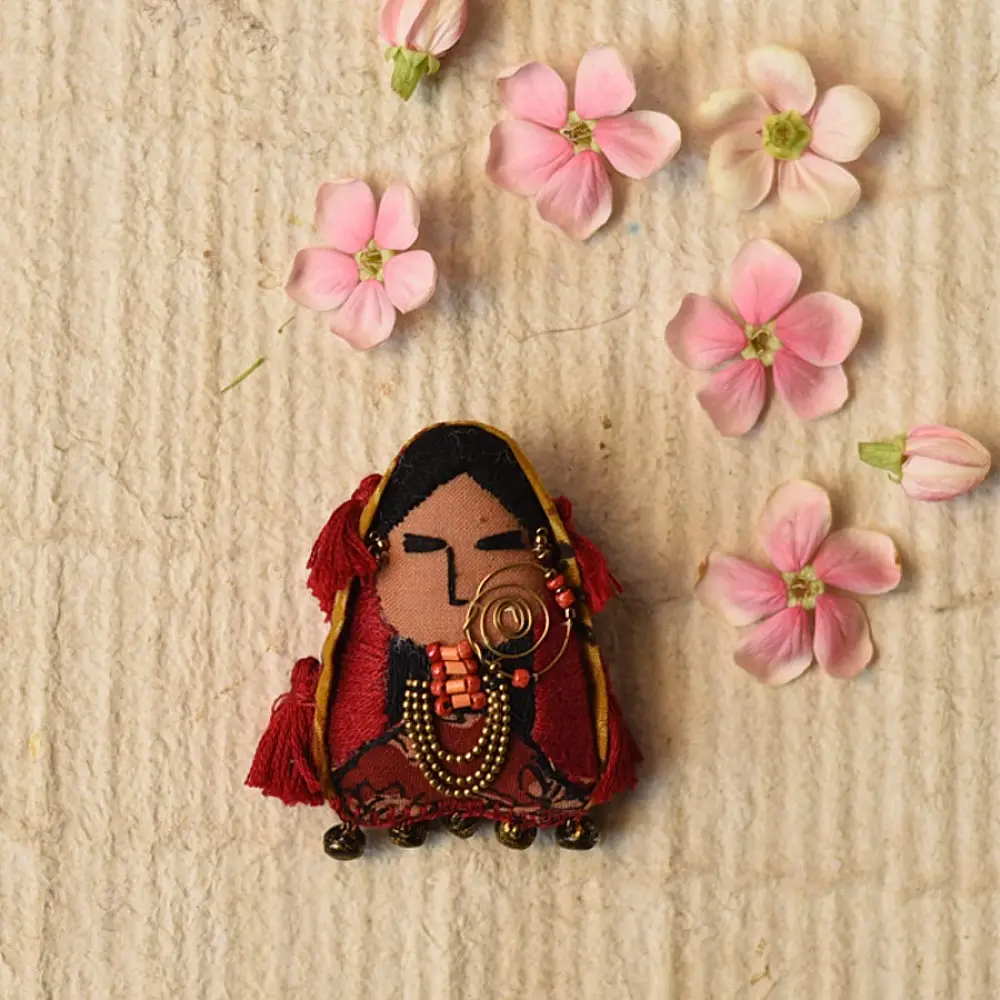 woman of kutchh hand embroidered fabric brooch pin with traditional large gold nose ring tribal jewelry thread tassels lapel badge gaatha