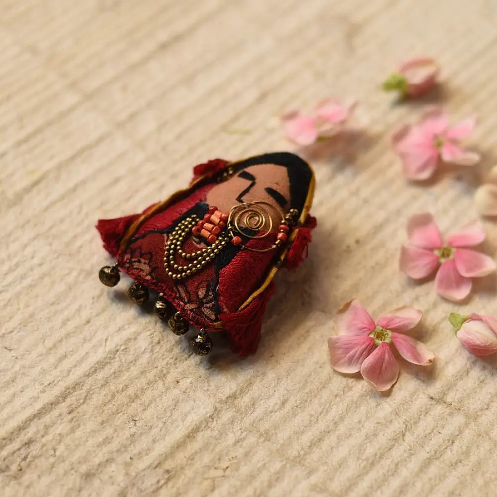 woman of kutchh hand embroidered fabric brooch pin with traditional large gold nose ring tribal jewelry thread tassels lapel badge gaatha